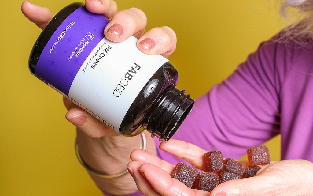 woman pouring fab cbd gummies for sleep into her hand