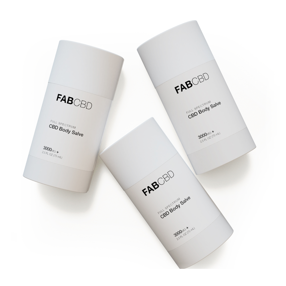 Top-down view of three tilted 2.5oz Salve - 3 Pack FAB CBD cylindrical white containers arranged in a loose triangle on a white background.
