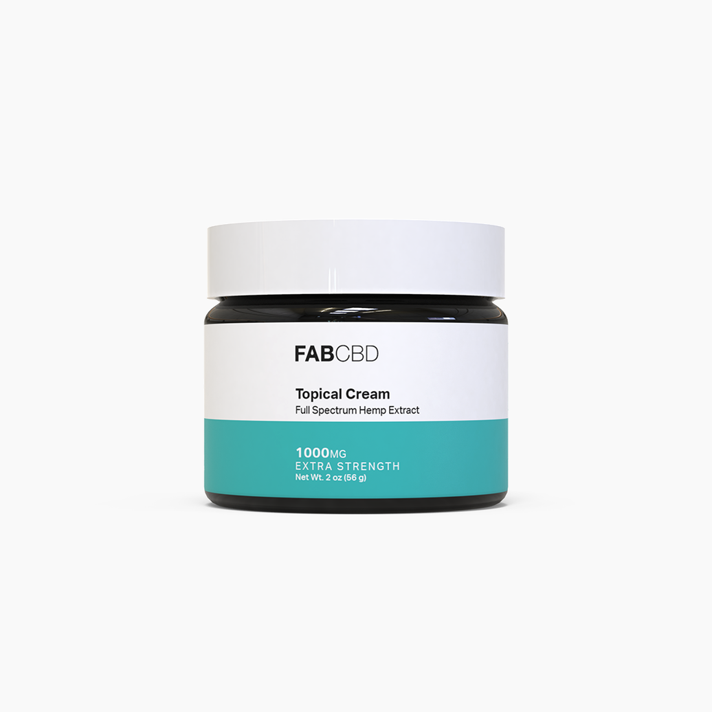 Center-frontal view of the FABCBD CBD Cream jar on a white background showing a white lid, black glass jar, and teal label band.