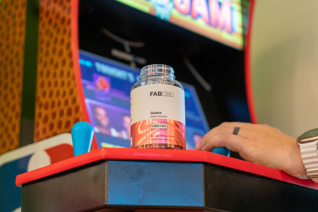 bottle of delta 9 THC gummies on top of an arcade game