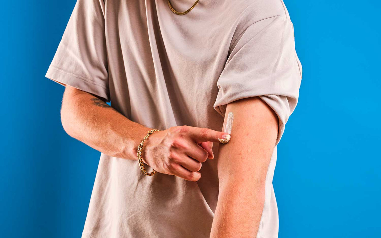 man applying cbd topical to arm