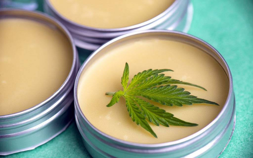 three CBD salve containers clustered together