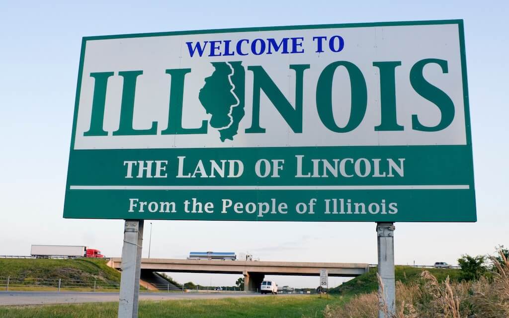 A highway sign for Illinois that says "Welcome to Illinois: The Land of Lincoln"