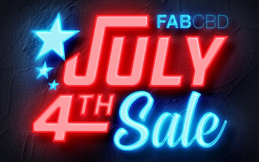 A neon sign saying "FAB July 4th Sale"