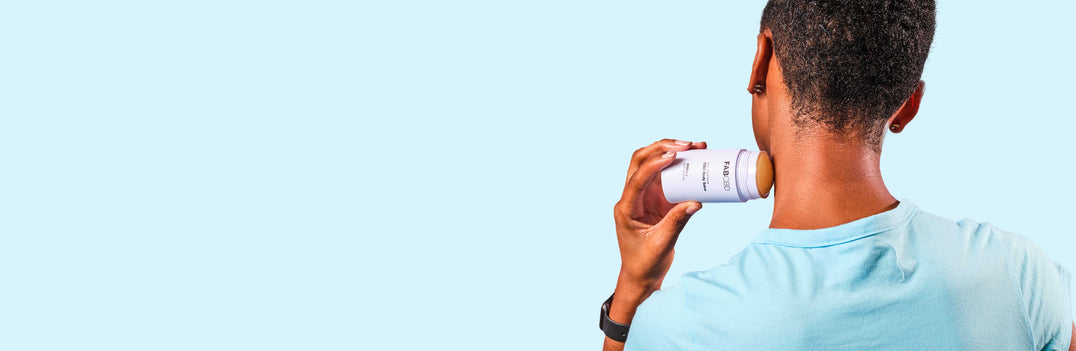 person applying cbd topical to their neck