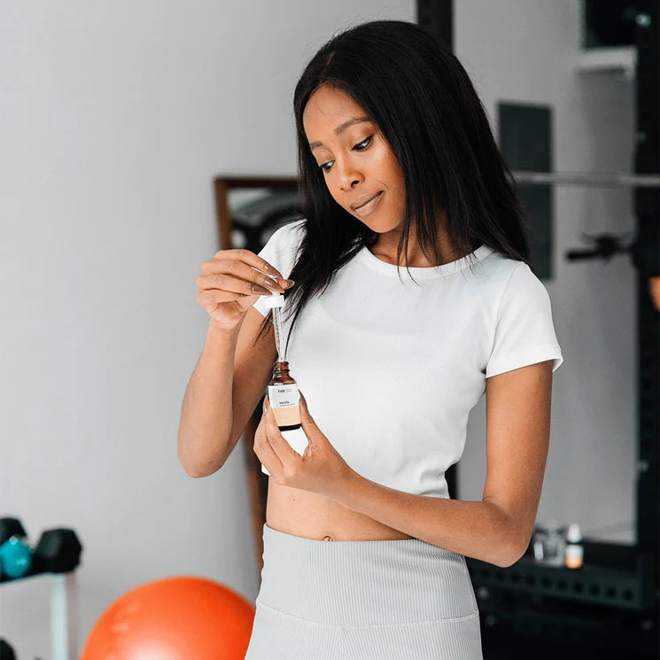 woman measuring dose of CBD oil