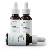 Three amber glass dropper bottles of FAB CBD 'Natural' Broad Spectrum CBD Oil with white caps and white labels featuring a green USDA Organic seal, two standing upright and one lying on its side showing '1200mg, 1 fl oz (30 mL), Dietary Supplement,' on a white background.