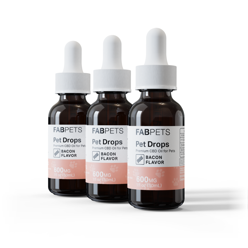 Three dark amber dropper bottles labeled Fab Pets Pet Drops with Bacon flavor and 600mg CBD, arranged in a row.