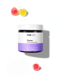 FAB CBD Chews jar with purple label and three red and yellow gummy candies on white background.