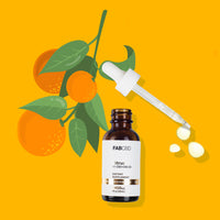 FAB CBD Citrus 1:1 CBD+CBG Oil in an amber dropper bottle with a white label, gold "Gold Standard" banner, 2400MG potency, and 1 fl oz (30mL) volume. An open dropper with falling oil droplets is positioned above the bottle, set against a graphic illustration of oranges and green leaves on a solid bright orange background.