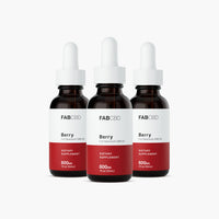 Front-facing trio of FABCBD CBD Oil berry-flavored 1 fl oz amber dropper bottles with white caps on a white background.