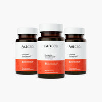 Three amber glass supplement bottles with white caps arranged in a tight cluster, with one bottle slightly in front of the other two, against a pure white background. Each bottle features FAB CBD branding for Complete Cannabinoid™ 1:1:1:1 Softgels and displays identical product specifications on its white and bright orange label: "CBC+CBG+CBD+CBN HEMP SUPPLEMENT," a potency of "15MG Per Serving," and a total count of "60 PLANT BASED SOFTGELS."
