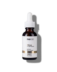 An amber dropper bottle of FAB CBD Citrus 1:1 CBD+CBG Oil dietary supplement. The white label features a gold "Gold Standard" banner and lists product specifications including a potency of 2400MG and a volume of 1 fl oz (30mL).