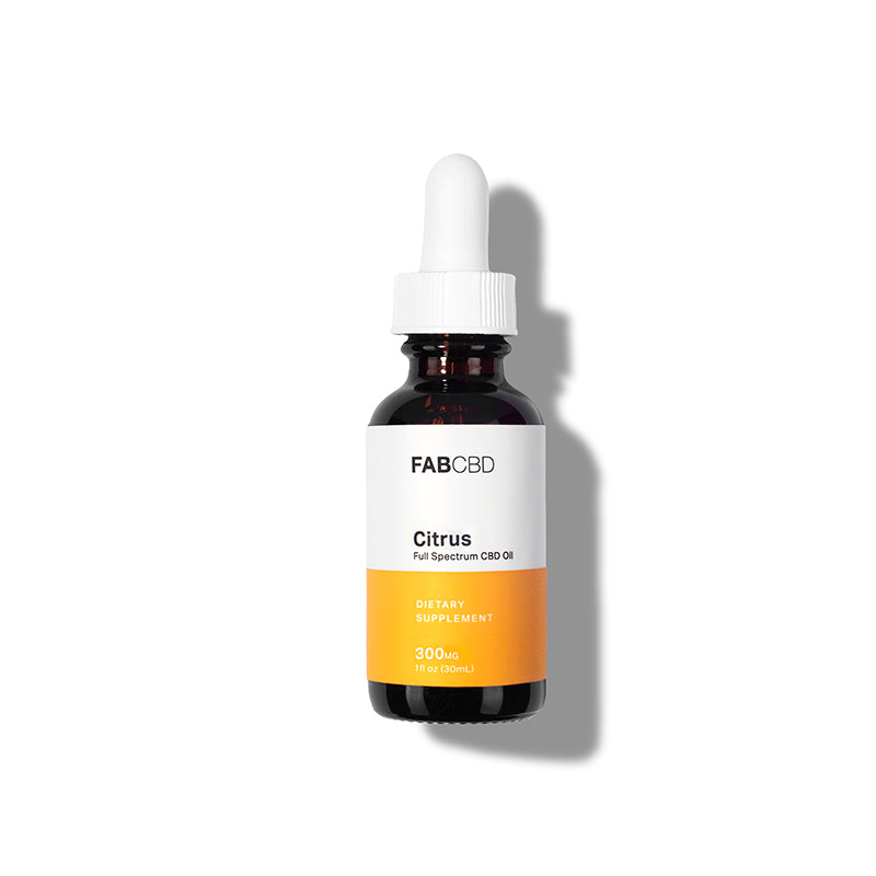 Front-lit, centered bottle of FABCBD CBD Oil with a white dropper and white-and-orange label casting a soft shadow to the right.