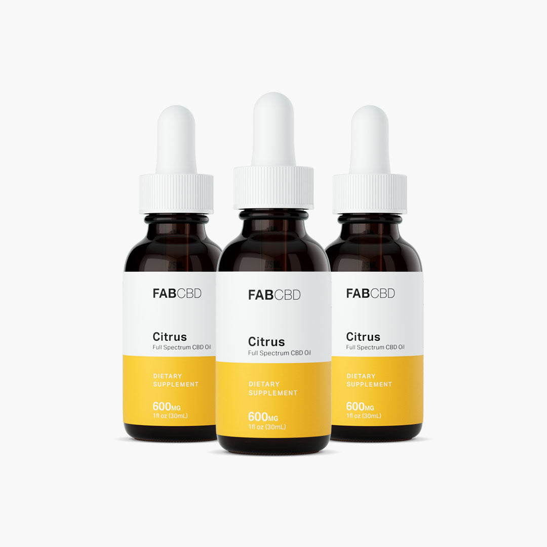 Front-facing trio of FABCBD CBD Oil dropper bottles with white caps and yellow labels on a white background.