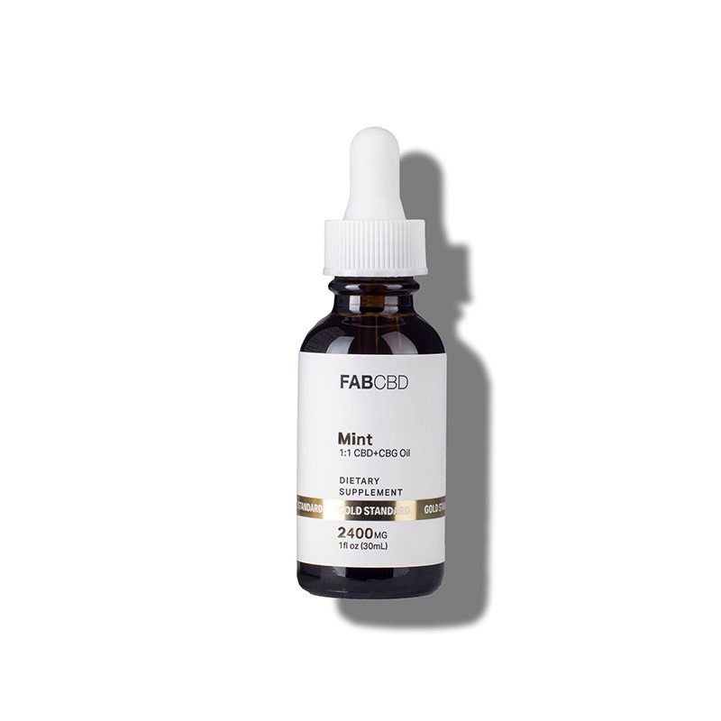 An amber dropper bottle of FAB CBD Mint 1:1 CBD+CBG Oil dietary supplement. The white label features a gold "Gold Standard" banner and lists product specifications including a potency of 2400MG and a volume of 1 fl oz (30mL).