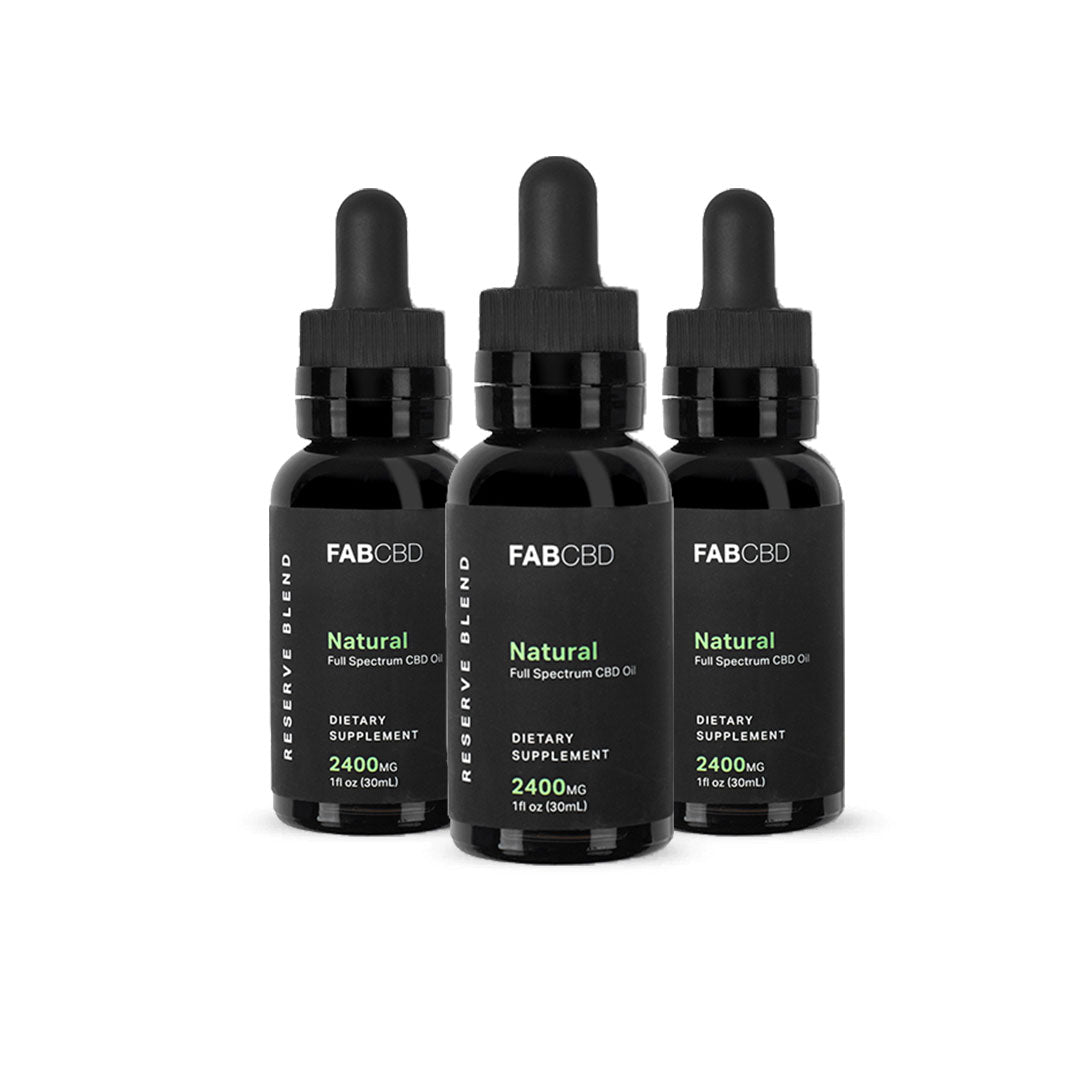 Three black 1 fl oz dropper bottles of FABCBD CBD Oil arranged in a triangular row on a white background, front labels visible.