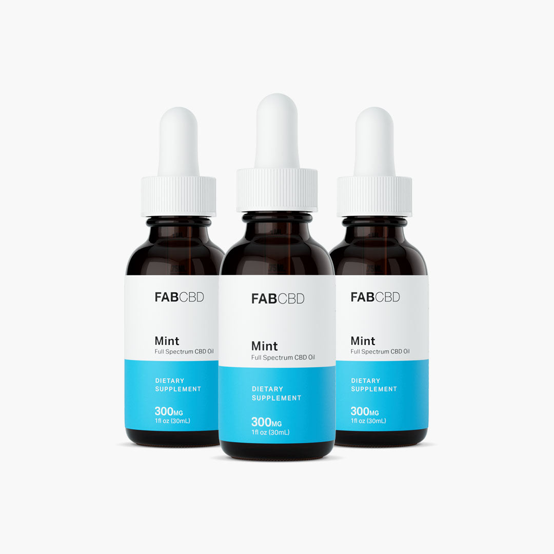 Front-facing trio of FABCBD CBD Oil mint bottles with white droppers and blue labels against a bright white background
