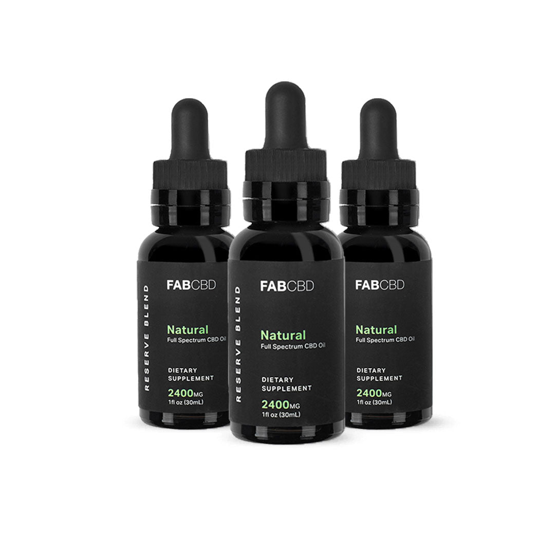 Front-facing trio of FAB CBD CBD Oil dropper bottles with black labels and green "Natural" text against a white background