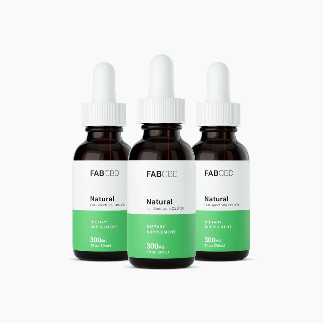Three front-facing FABCBD CBD Oil dropper bottles in amber glass with white caps and green-and-white labels against a white background.