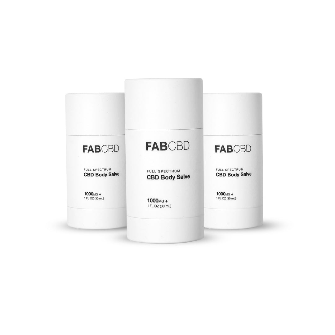 Three white cylindrical containers in a row photographed front-on, showing the FAB CBD CBD Body Salve labels against a bright white background.