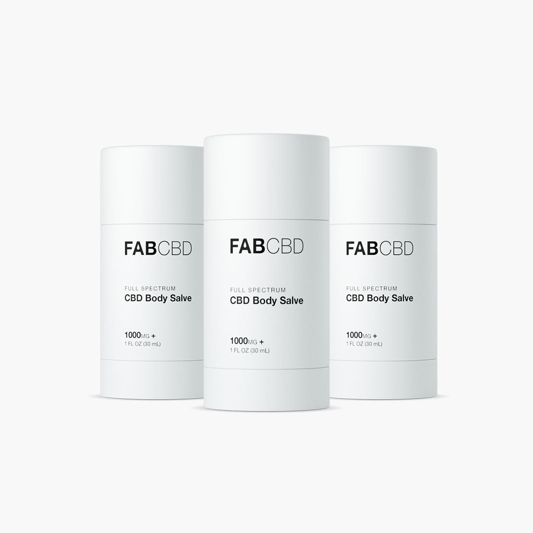 Front-facing trio of FABCBD CBD Body Salve cylinders in matte white packaging arranged evenly against a soft white background.