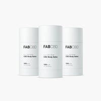 Front-facing trio of FABCBD CBD Body Salve cylinders in matte white packaging arranged evenly against a soft white background.