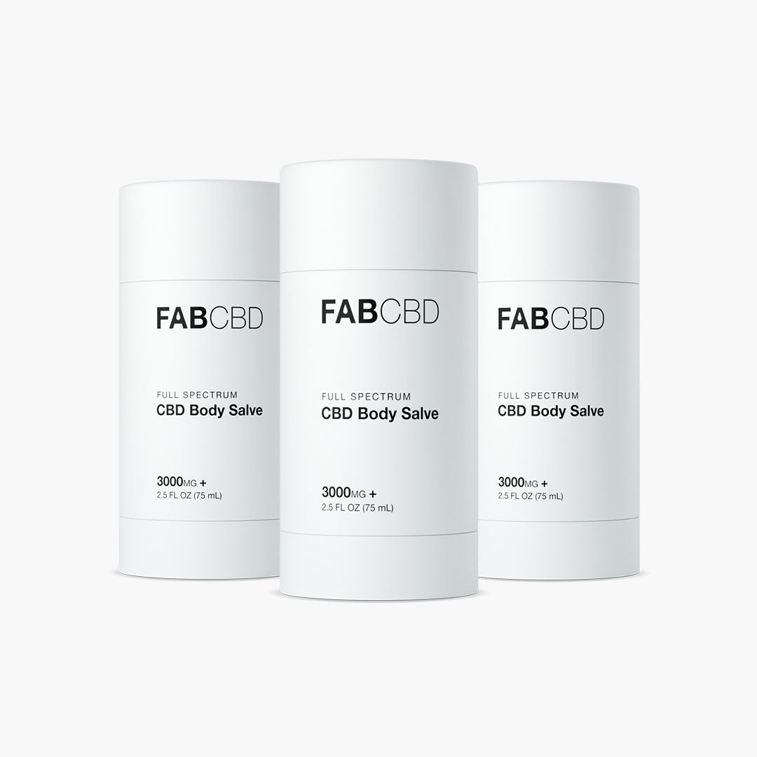 Front view of three white FABCBD CBD Body Salve cylinders with minimalist black text, centered against a soft white background.