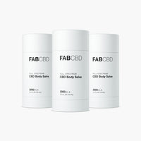 Front view of three white FABCBD CBD Body Salve cylinders with minimalist black text, centered against a soft white background.