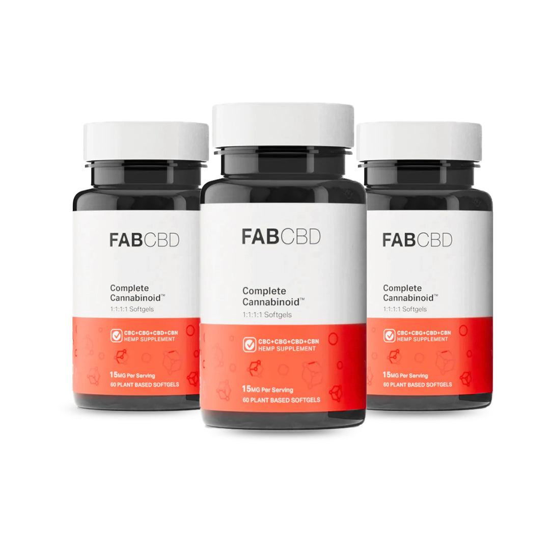 Three amber glass supplement bottles with white caps standing side-by-side in a row against a pure white background. Each bottle features the FAB CBD branding for Complete Cannabinoid™ 1:1:1:1 Softgels and displays identical product specifications on its white and bright orange label: "CBC+CBG+CBD+CBN HEMP SUPPLEMENT," a potency of "15MG Per Serving," and a count of "60 PLANT BASED SOFTGELS."