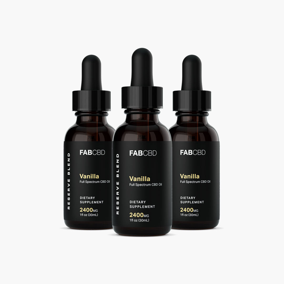 Center-front view of three FABCBD CBD Oil vanilla bottles with black droppers and black labels on a white background.