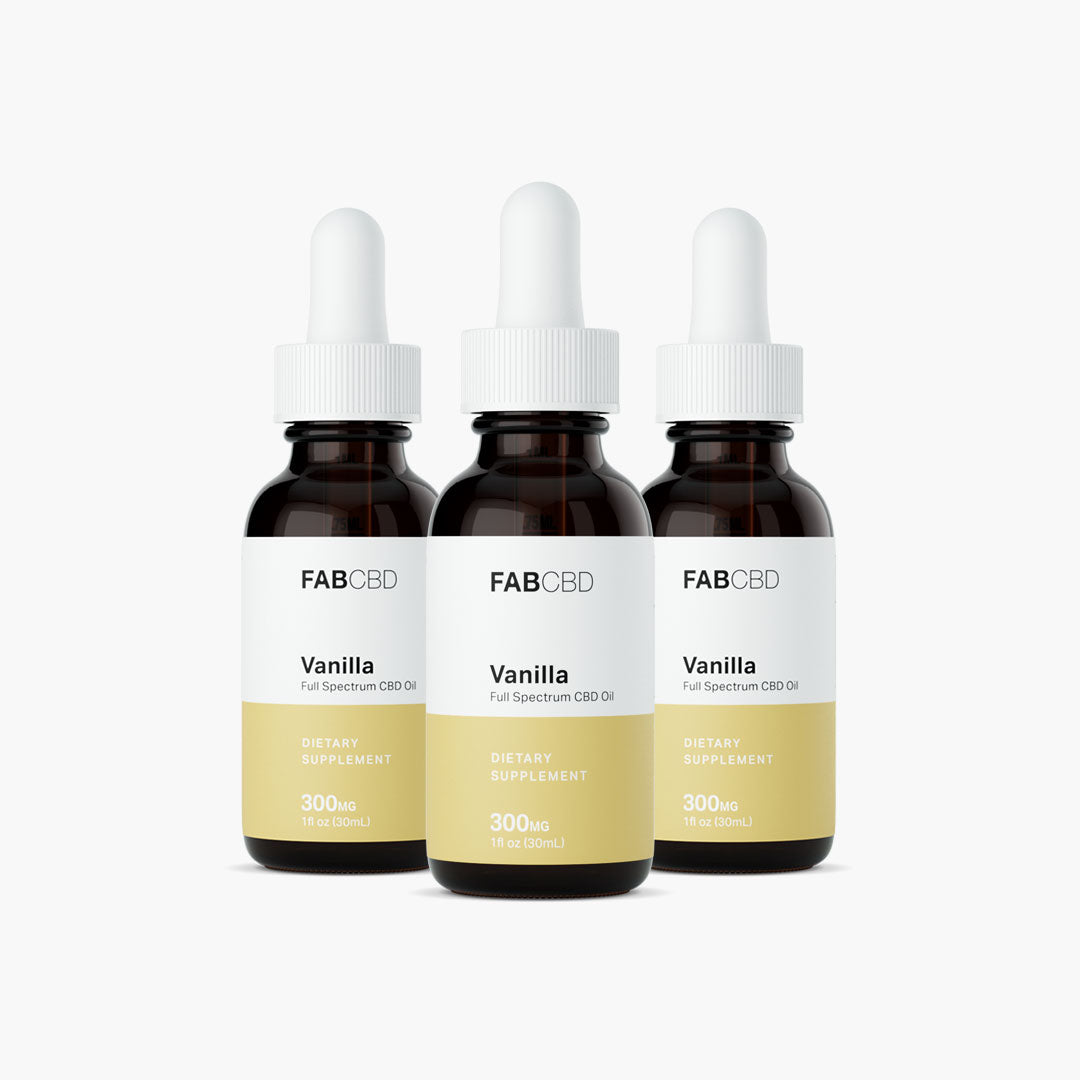 Front-facing trio of FABCBD CBD Oil vanilla 300mg dropper bottles with white labels and gold bands against a white background.
