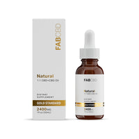 An amber dropper bottle of FAB CBD Natural 1:1 CBD+CBG Oil dietary supplement standing next to its white cardboard packaging box. Both the bottle label and the front of the box display the product specifications "2400MG" and "1 fl oz (30mL)" beneath a gold "Gold Standard" banner, set against a solid white background.
