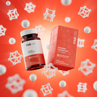 A dynamic product graphic featuring a FAB CBD Complete Cannabinoid™ 1:1:1:1 Softgels amber glass bottle and its matching bright orange cardboard packaging box floating at an angle. The products are surrounded by floating white spheres and 3D molecular structure models against a vibrant red-orange background. Both items clearly display key product specifications: "CBC+CBG+CBD+CBN HEMP SUPPLEMENT," a potency of "15MG Per Serving," and a count of "60 PLANT BASED SOFTGELS."